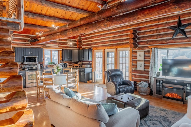 living room with wood ceiling, beamed ceiling, and light wood-type flooring