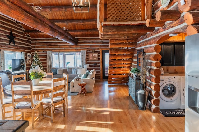 dining area featuring beamed ceiling, washing machine and dryer, hardwood / wood-style flooring, and wood ceiling