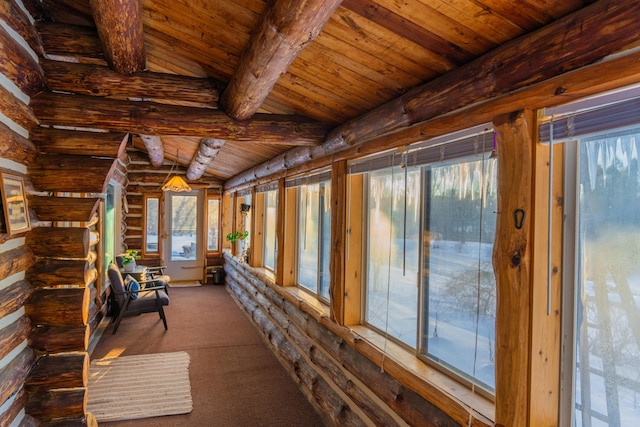 unfurnished sunroom featuring wood ceiling and lofted ceiling with beams