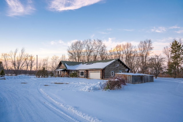 view of snow covered exterior featuring a garage