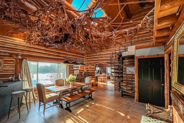 dining room with rustic walls and a high ceiling