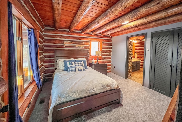 bedroom with carpet, connected bathroom, wood ceiling, and beam ceiling