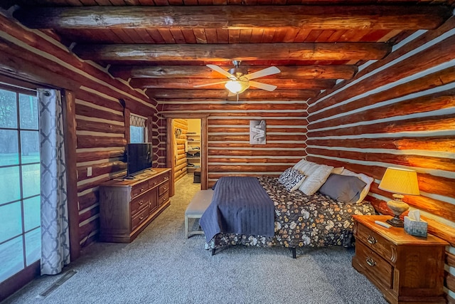 carpeted bedroom featuring beamed ceiling and wood ceiling