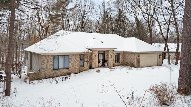 view of front facade featuring brick siding and an attached garage