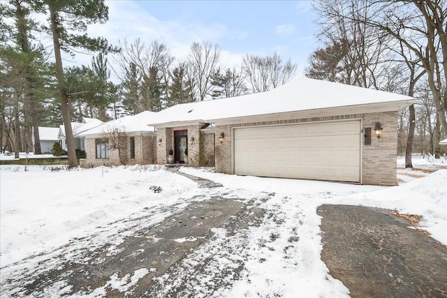 view of front of house with a garage and brick siding