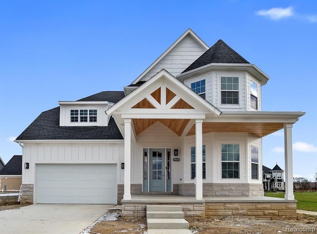 view of front of house with a porch and a garage