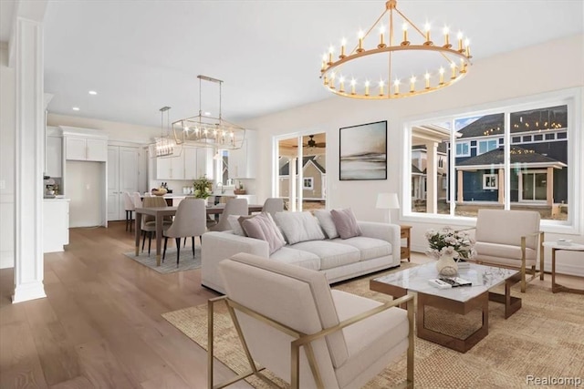 living room with ceiling fan and light hardwood / wood-style floors