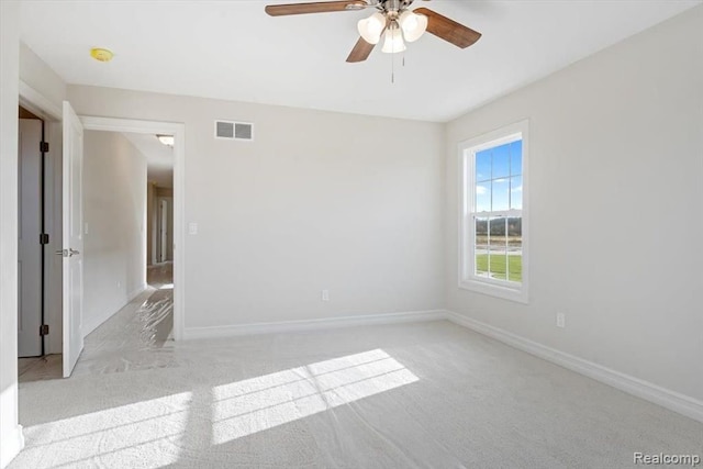 spare room with light carpet and ceiling fan