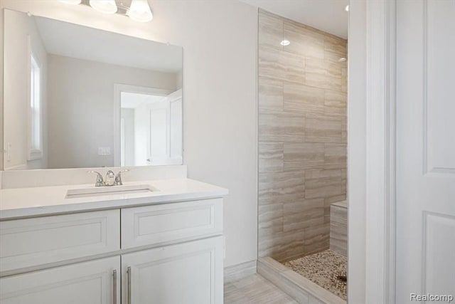 bathroom featuring vanity and a tile shower