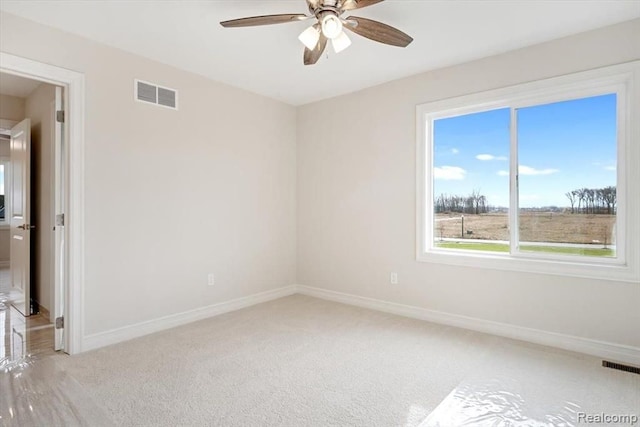 carpeted empty room featuring ceiling fan