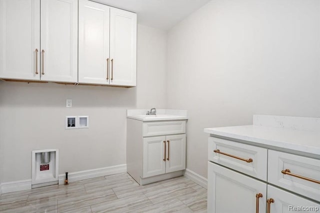 laundry area featuring washer hookup, sink, and cabinets