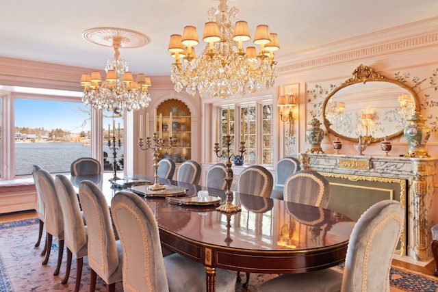 dining space featuring a water view, an inviting chandelier, and crown molding