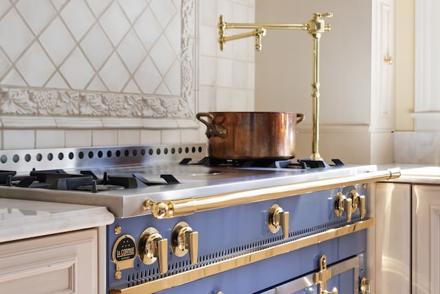 interior details featuring blue cabinets and backsplash