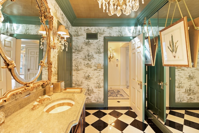 bathroom featuring a chandelier, crown molding, and vanity