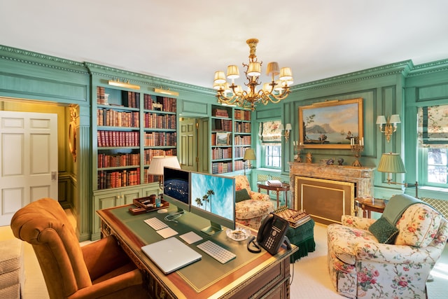 office with a notable chandelier, ornamental molding, built in shelves, and light carpet