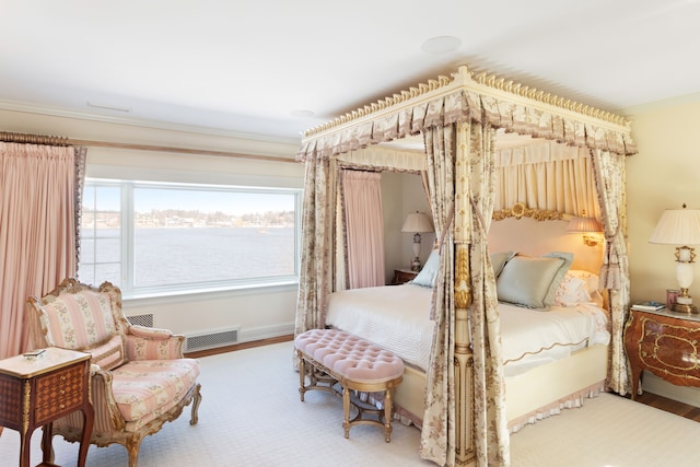 bedroom featuring a water view and wood-type flooring