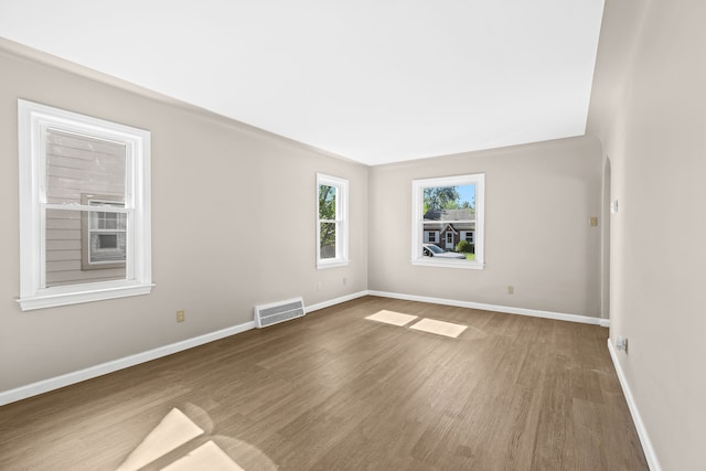 unfurnished room featuring hardwood / wood-style flooring