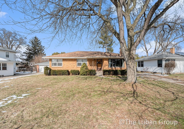 ranch-style home with a garage and a front lawn