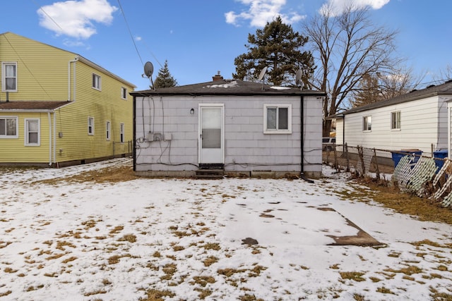 view of snow covered rear of property