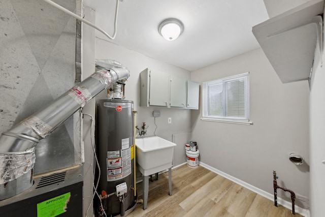 utilities with sink and gas water heater