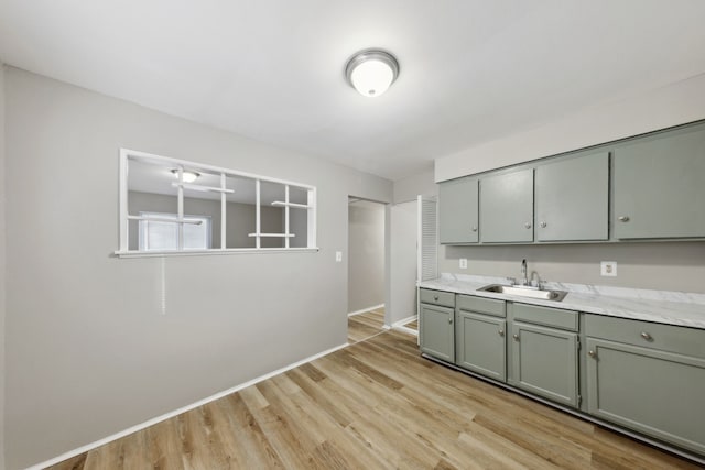 kitchen featuring sink and light wood-type flooring