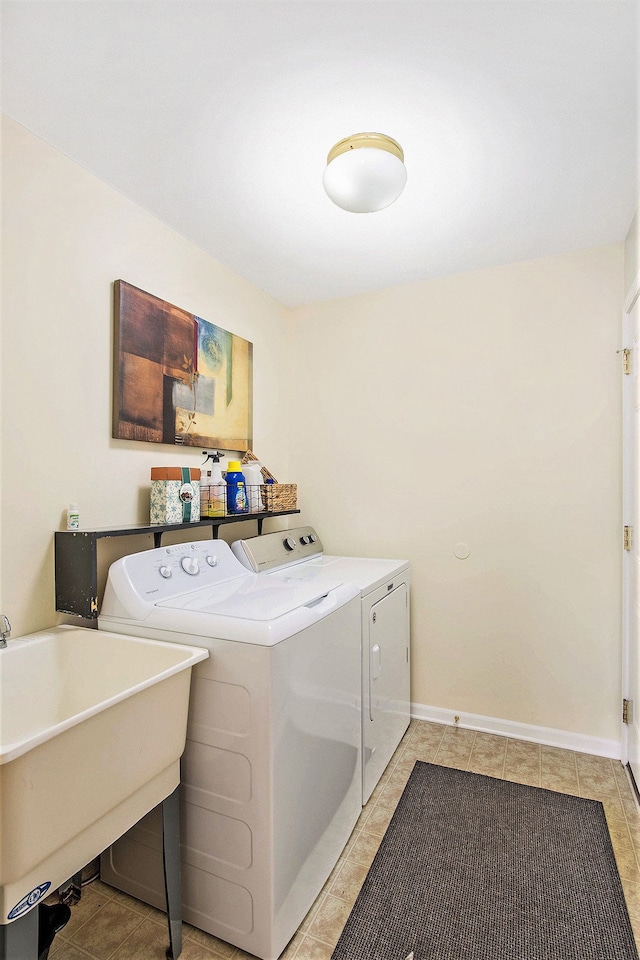 clothes washing area featuring washing machine and dryer and sink