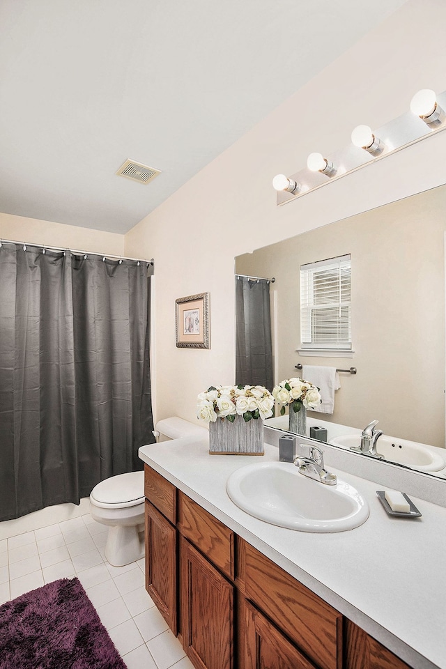 bathroom with vanity, tile patterned flooring, and toilet