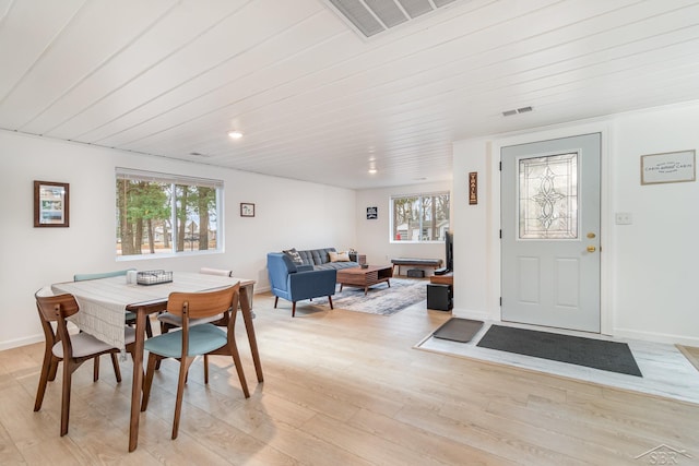 dining space with wood ceiling and light hardwood / wood-style flooring