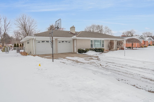 view of snowy exterior featuring a garage