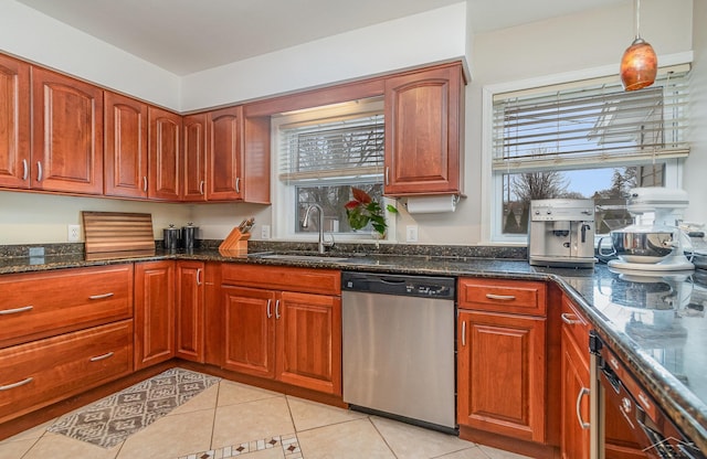 kitchen featuring light tile patterned flooring, pendant lighting, dishwasher, sink, and dark stone countertops