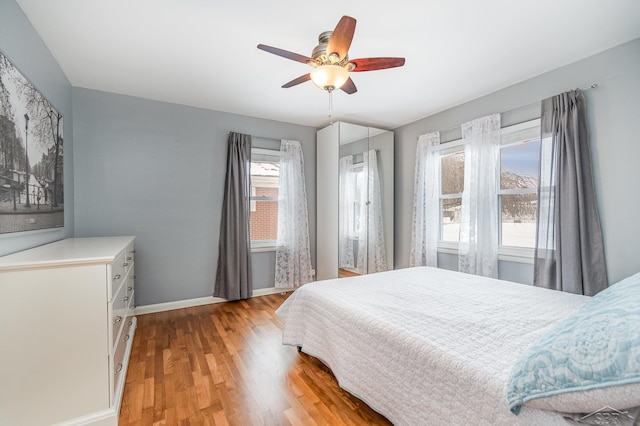 bedroom with ceiling fan and light wood-type flooring