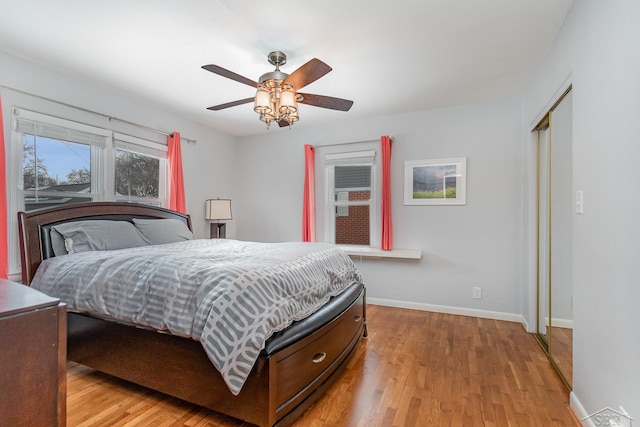 bedroom with a closet, ceiling fan, and light hardwood / wood-style flooring