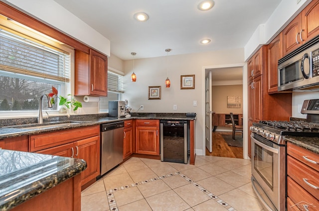 kitchen featuring wine cooler, light tile patterned flooring, sink, pendant lighting, and stainless steel appliances