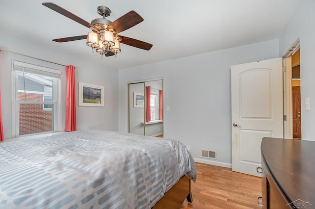 bedroom featuring light hardwood / wood-style floors, a closet, and ceiling fan