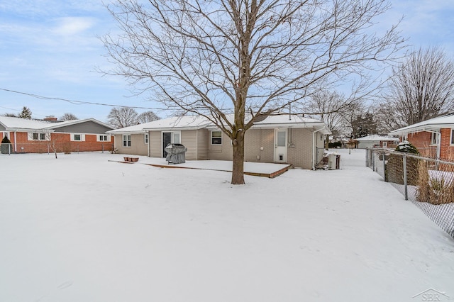 view of snow covered back of property