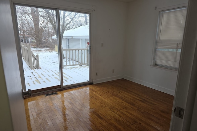 30052 Schoenherr Rd, Warren, MI 48088 - empty room with wood-type flooring, visible vents, and baseboards