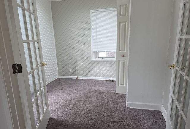 30052 Schoenherr Rd, Warren, MI 48088 - unfurnished room with wood walls, baseboards, dark colored carpet, and french doors