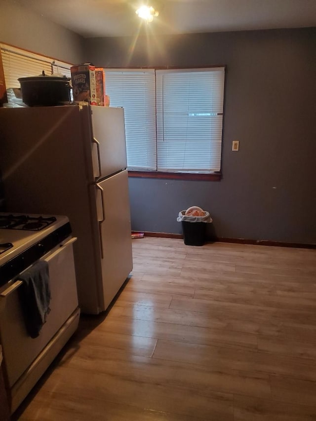 kitchen featuring white gas range and light hardwood / wood-style floors