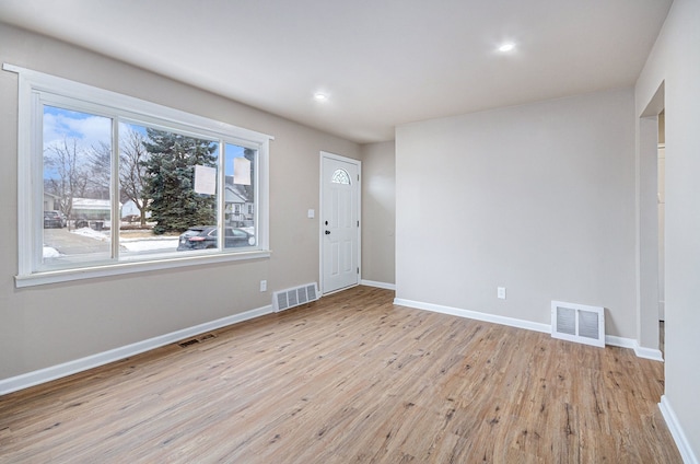 interior space featuring visible vents, baseboards, and wood finished floors