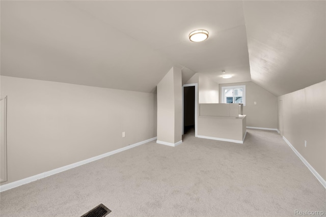 23225 Beverly St, Saint Clair Shores, MI 48082 - additional living space with light colored carpet, vaulted ceiling, and baseboards