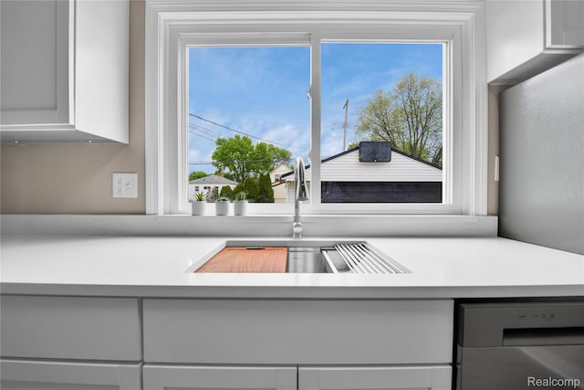 23225 Beverly St, Saint Clair Shores, MI 48082 - kitchen view of dishwasher, a sink, and light countertops