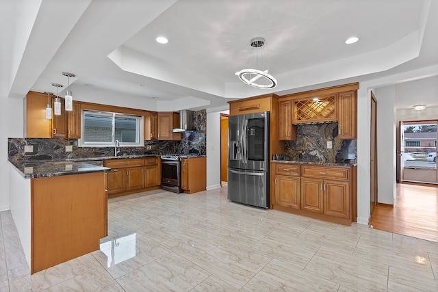 kitchen with pendant lighting, stainless steel appliances, and a raised ceiling