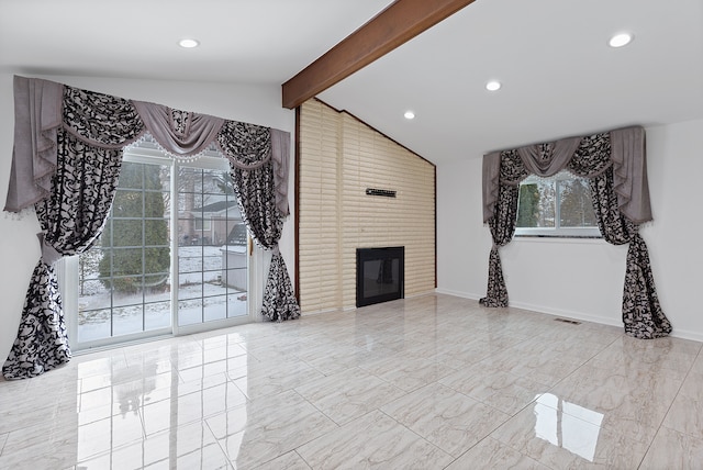 living room featuring a fireplace and vaulted ceiling with beams