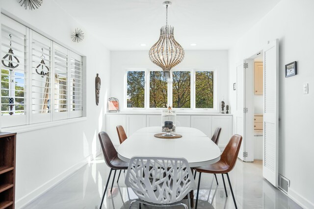 19300 Highland Dr, New Buffalo, MI 49117 - dining area with finished concrete flooring, visible vents, baseboards, an inviting chandelier, and recessed lighting