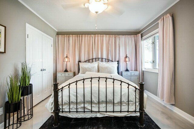 19300 Highland Dr, New Buffalo, MI 49117 - bedroom with a closet, a ceiling fan, crown molding, and baseboards