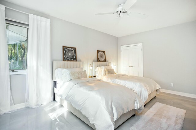 19300 Highland Dr, New Buffalo, MI 49117 - bedroom featuring wood finished floors, a closet, baseboards, and ceiling fan
