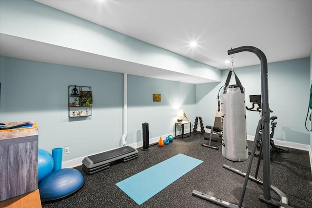 workout area featuring baseboards and recessed lighting