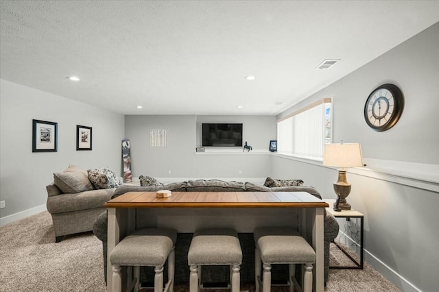 living area featuring recessed lighting, carpet flooring, visible vents, and baseboards