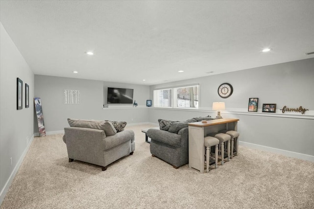 carpeted living room featuring recessed lighting, visible vents, and baseboards