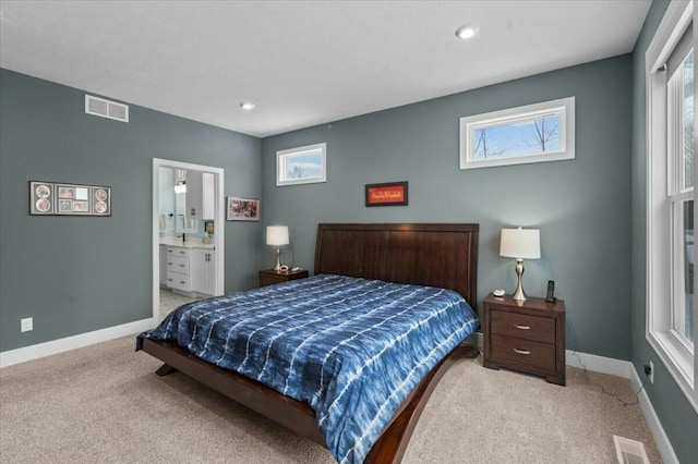 bedroom with baseboards, visible vents, and light colored carpet